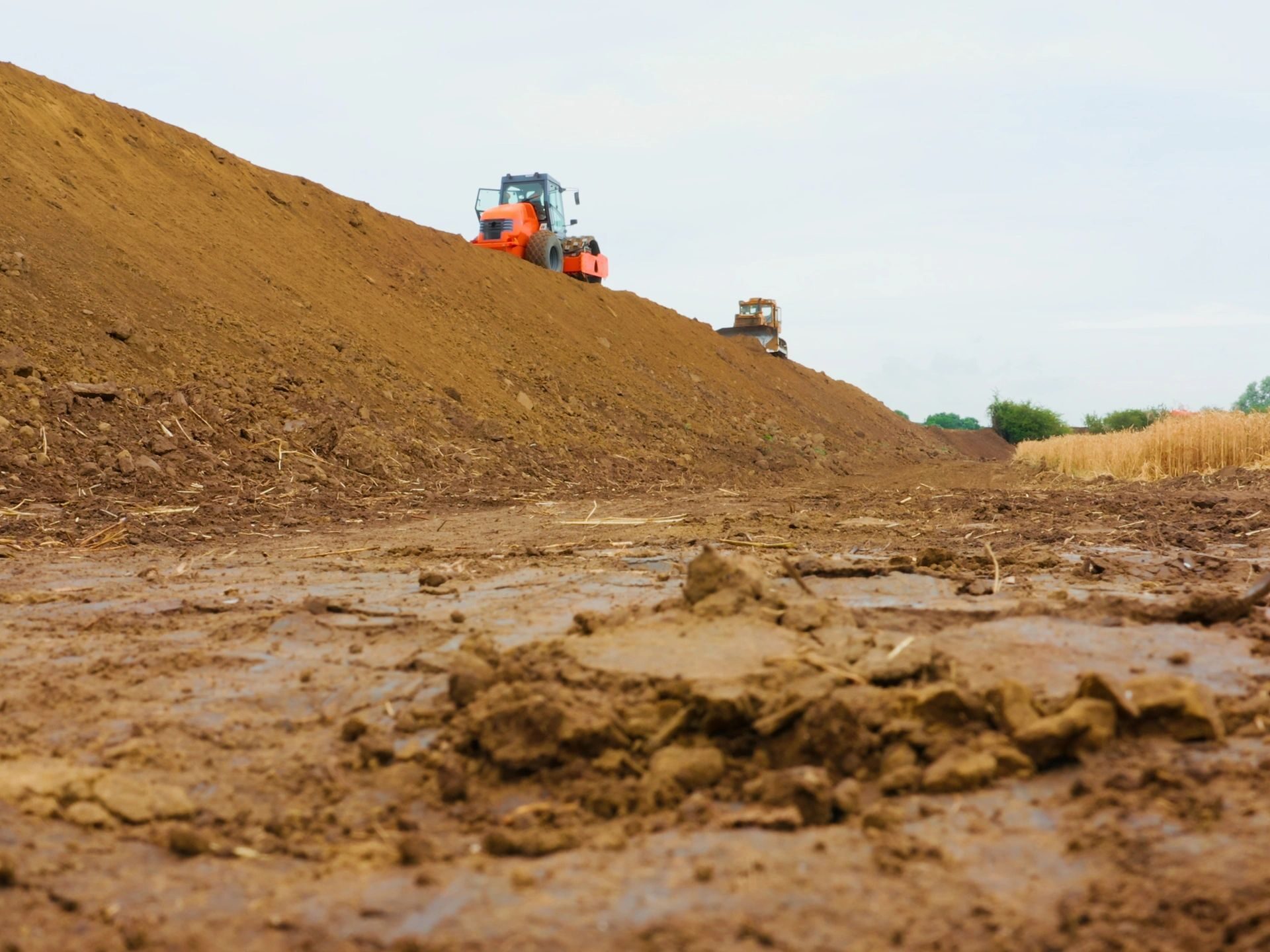 Earthworks machinery leveling ground at a construction site